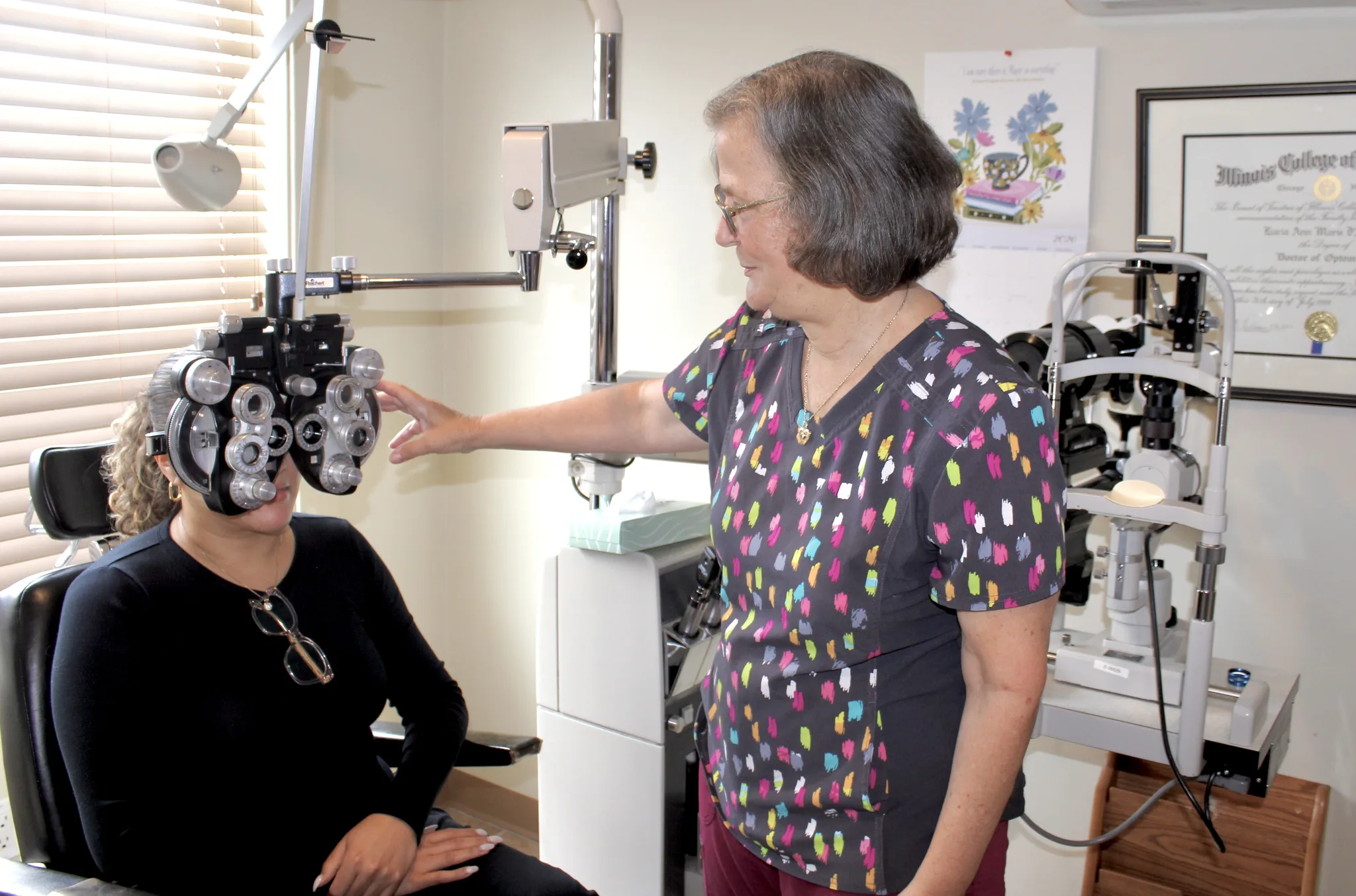 An eye-care professional conducting a vision examination in the Cranston office.